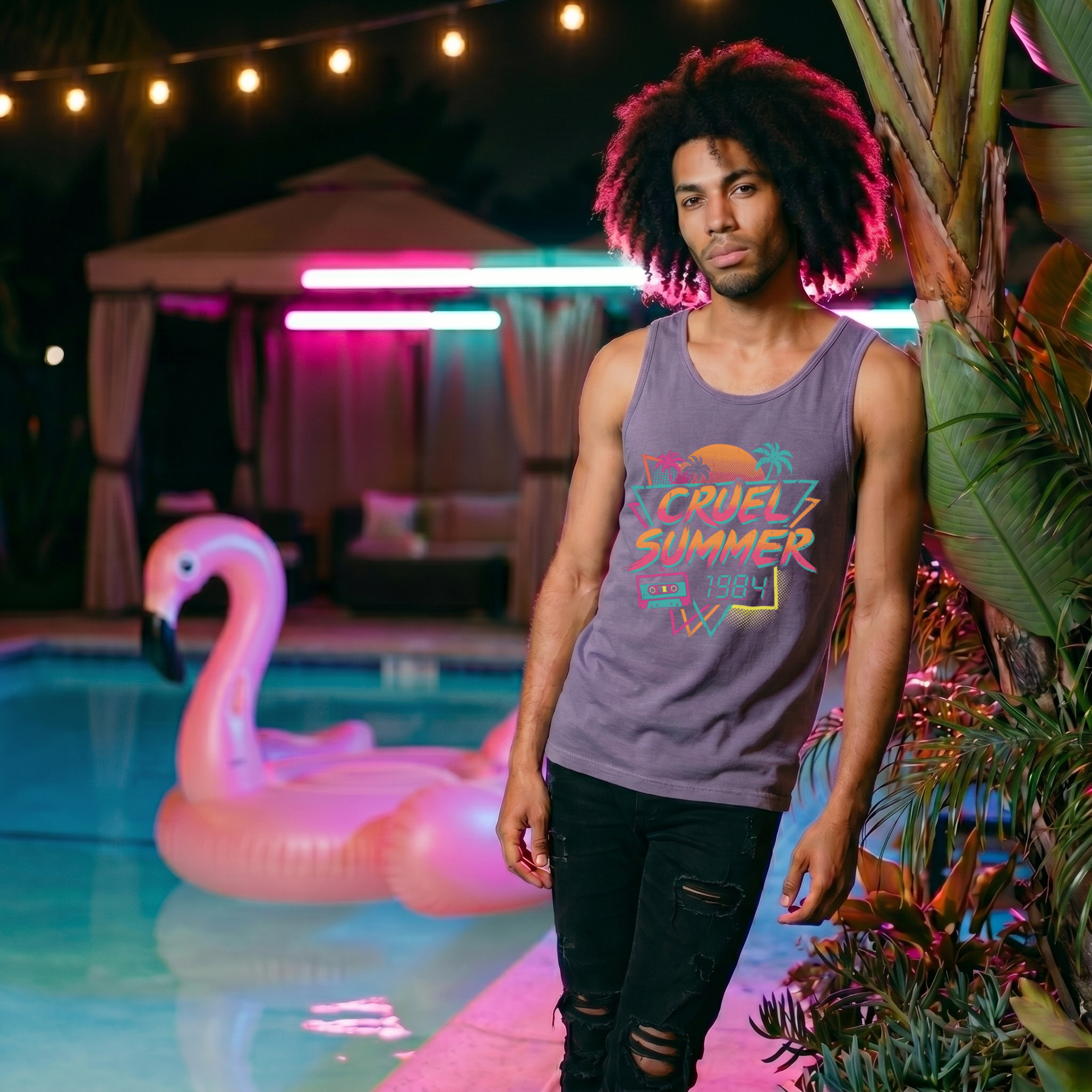 Man with an afro leaning by a palm tree wearing a heather purple Cruel Summer 1984 tank top, with a flamingo pool float in the background