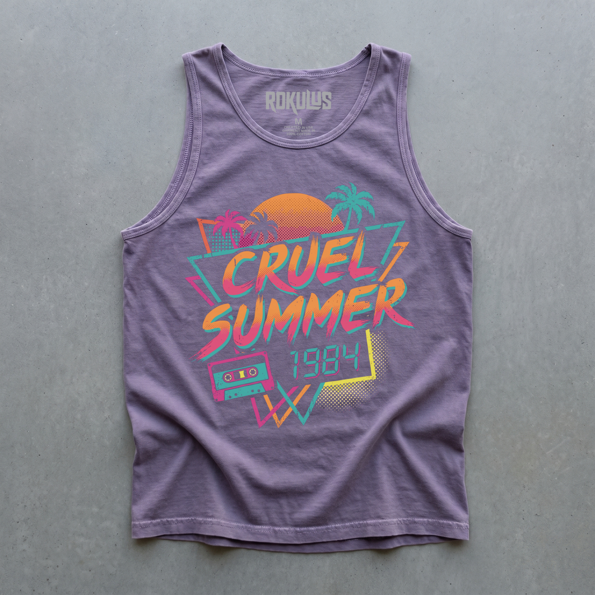 Heather purple tank top laid flat on concrete, showing the Cruel Summer 1984 neon graphic with palm trees, sunset, and a cassette tape, plus the Rokulus inner-neck label